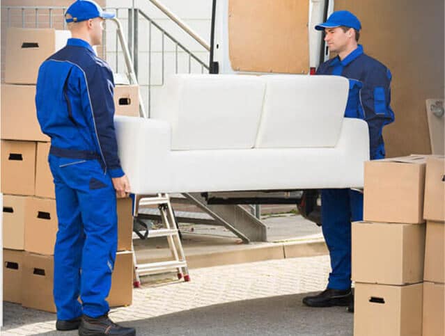 Two removalists moving furniture